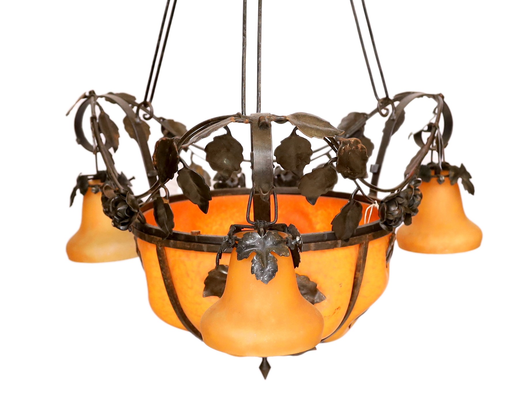 A 1930s French wrought iron and orange marbled glass light fitting decorated with rose motifs, height 97cm. width 57cm